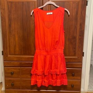 Orange sleeveless dress with cinched waist and ruffle bottom